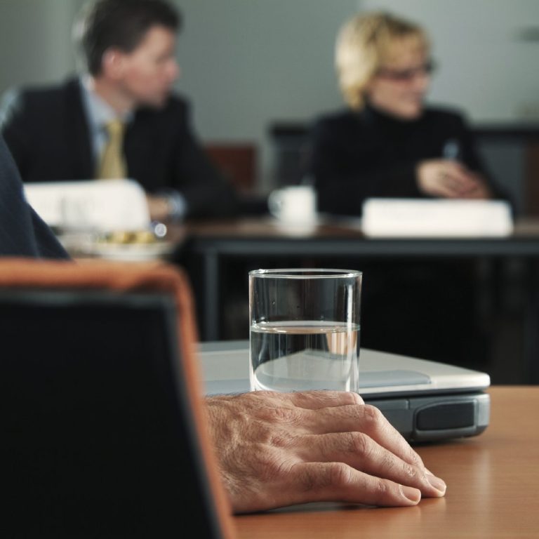water glass in room of people